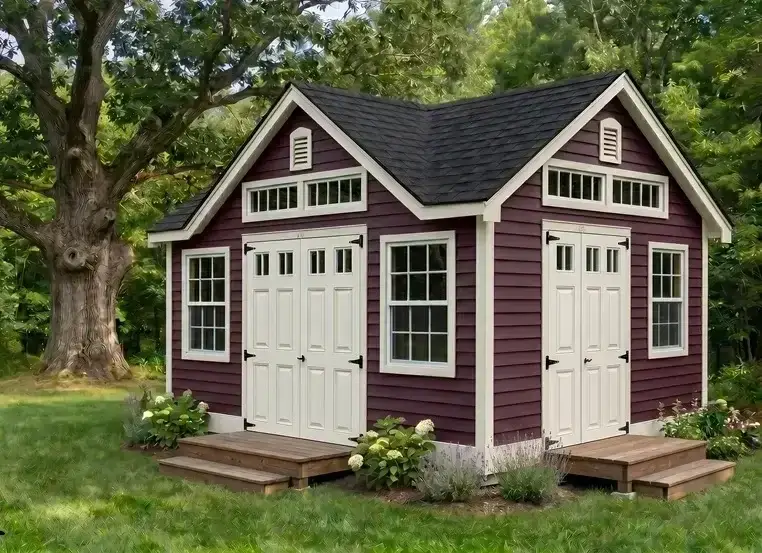 Appalachian Country Cottage A-frame dormer shed with burgundy vinyl lap siding in a summer setting
